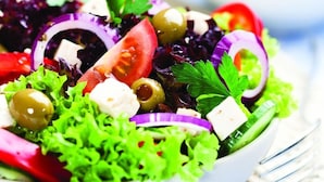 A bowl of salad with various vegetables and cheese. - Embassy Suites By Hilton Auburn Hills (Auburn Hills)