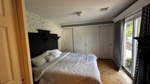 A bedroom with a bed, a wardrobe, a ceiling light, and a window with curtains. - Cozy 2-bedroom apartment in beautiful Ewing Township with AC (Ewing Township)