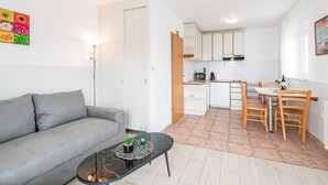 A modern apartment with a living room, kitchen, and dining area. - Apartment for 2 persons with sea view (Crikvenica)