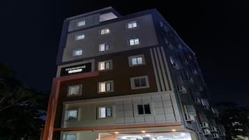 A multi-story building with a sign reading "TOWNHOUSE" and "Company Services."