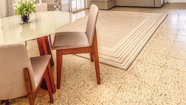 A spacious living area with a dining table, chairs, a sofa, and a large rug. - Casa Nube (Caguas)