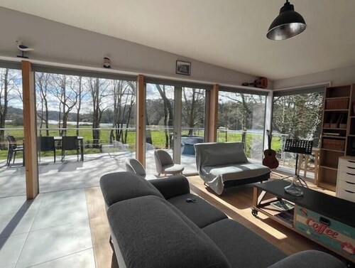 Architectural wooden house with spa on the banks of the Vilaine river