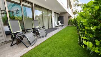 A modern building with a well-maintained lawn and outdoor seating area.
