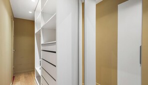 A narrow hallway with a white closet and shelving unit. - Appartement d'exception a Saint-Germain-des-Pres (Paris)
