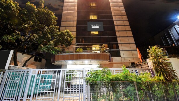 A multi-story building with a sign reading 'Townhouse.'