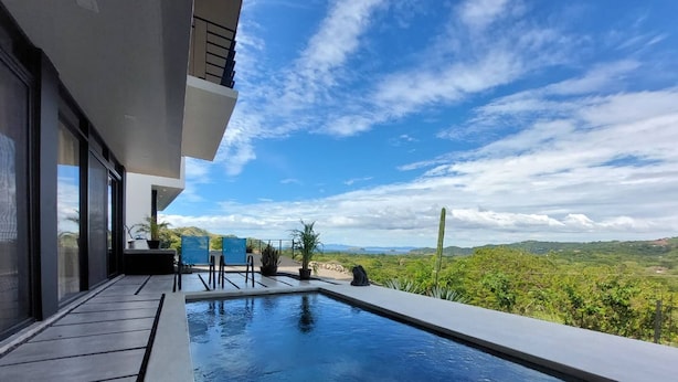 A modern outdoor pool with a clear view of the surrounding landscape. - Oceanview Modern Guest House With Pool (Sardinal)