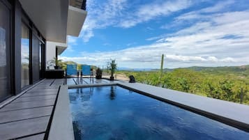 A modern outdoor pool with a clear view of the surrounding landscape.
