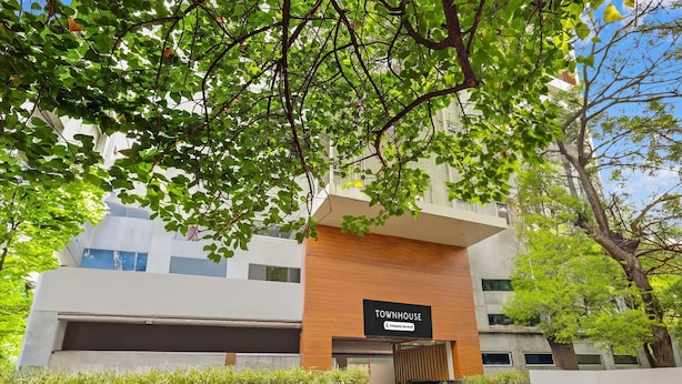 A modern building with a sign reading 'TOWNHOUSE & Company Services.' - Deluxe With Twin Bed The Pallagio (Visakhapatnam)
