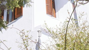 A white building with wooden shutters and a clear blue sky. - Dual bay views by ΜΡS (Μαρίστρα)