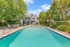 A swimming pool with a wooden deck, lounge chairs, and a house in the background. - New Listing! 1 Block to Beach! 806 Carolina (Isle of Palms)