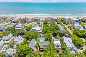 A coastal residential area with houses, a swimming pool, and a beach in the background. - New Listing! 1 Block to Beach! 806 Carolina (Isle of Palms)
