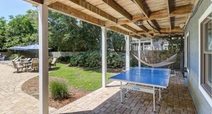 A covered outdoor area with a ping pong table, outdoor seating, and a hammock. - New Listing! 1 Block to Beach! 806 Carolina (Isle of Palms)
