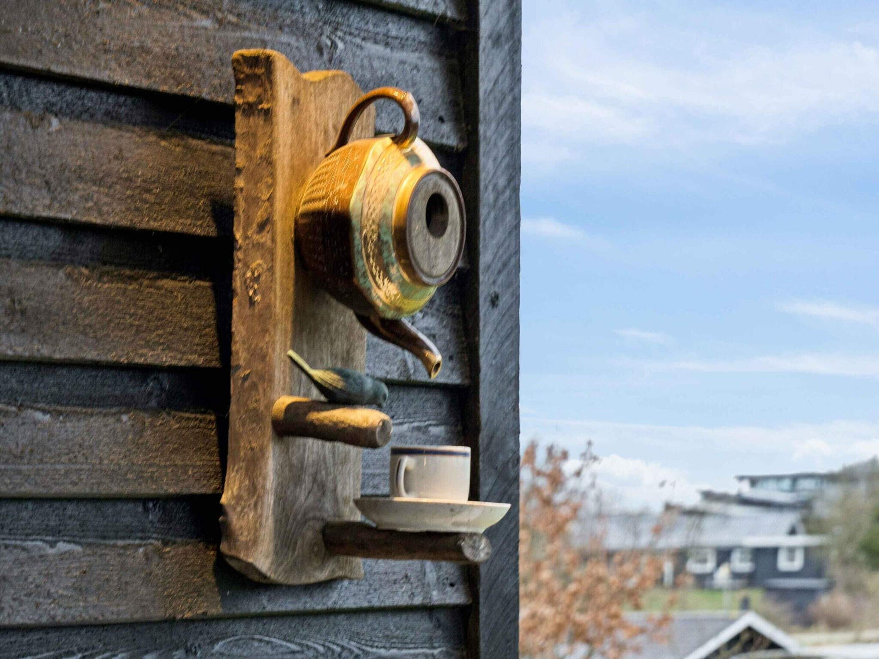 A wooden door with a traditional tea set, including a teapot, cup, and saucer.