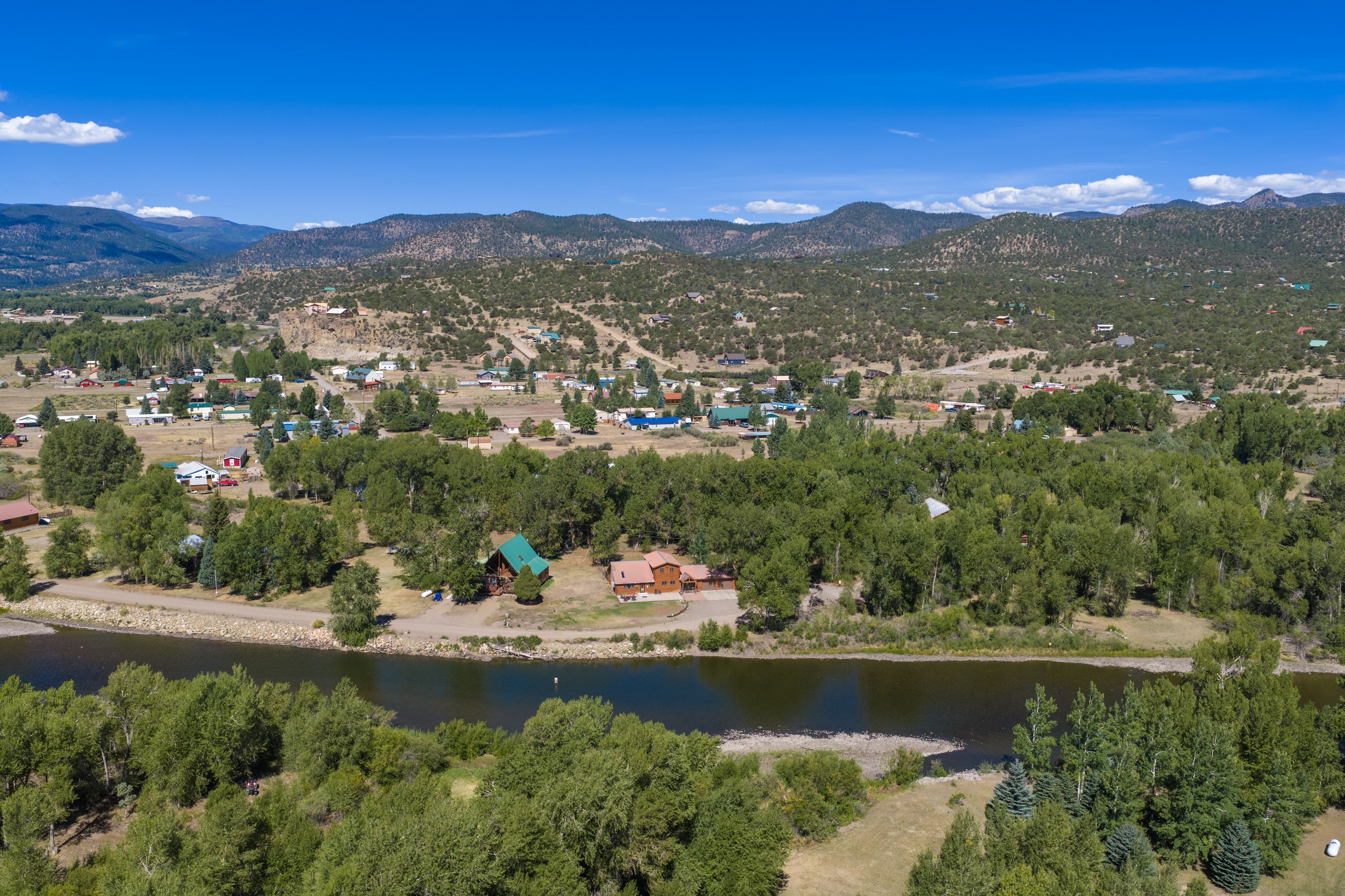 Vista lacustre de un pequeño pueblo con casas y un río.