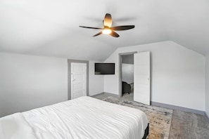 A bedroom with a bed, a ceiling fan, a TV mounted on the wall, and an open closet. - 3BR, Quiet Street, 10 Min DTW (Cincinnati)