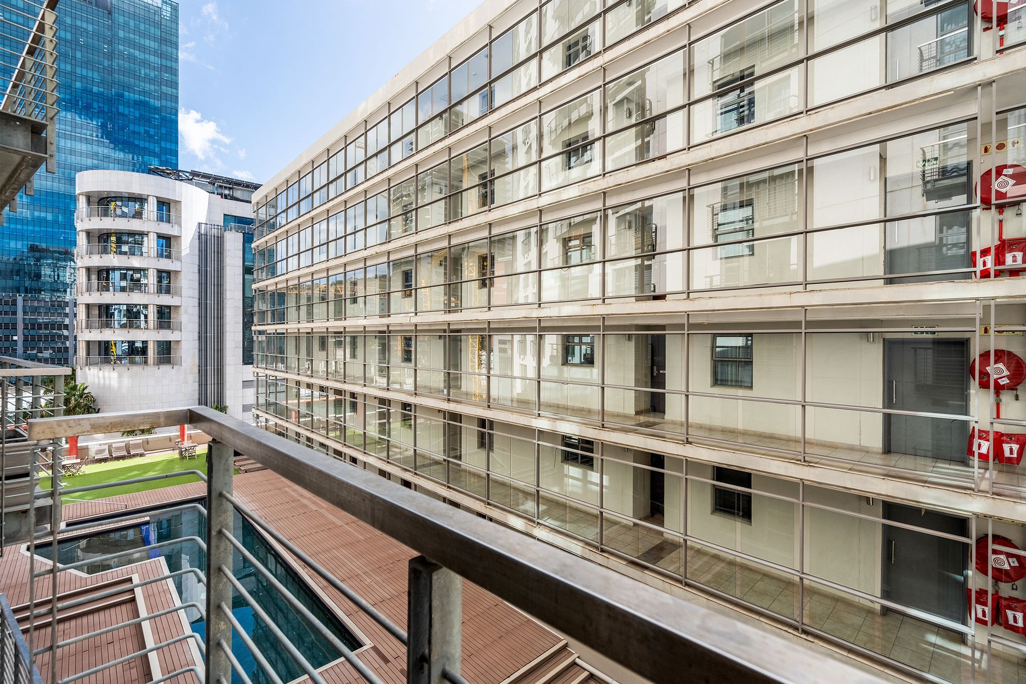 A modern building with multiple floors, large windows, and a glass facade.