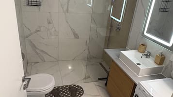Shower, hair dryer, towels, toilet paper