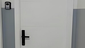 A closed white door with a black handle and a keyhole. - Residencial Felicita (Barueri)