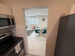 A kitchen with a microwave, oven, and refrigerator. - Modern 2BR in Bay Harbor Islands close to beach, shops, and dining (Bay Harbor Islands)