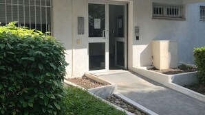 A modern building with a flat facade, large windows, and a central entrance with glass doors. - Haven of peace (Montpellier)