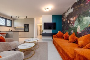 A modern living room with a sofa, coffee table, and a TV. - Seaside Luxury Apartment Infinity Blue A1 (Zadar)