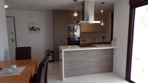 A modern kitchen with a central island, built-in oven, and pendant lighting. - Luxury 3 Bed 2 Bath Apt Near La Fuente Center, Beaches, Golf & Sun (VC)