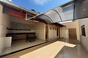 A modern interior with a kitchen area, a dining space, and a shower.