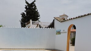 A clear swimming pool with a tiled edge, a white wall with a decorative border, and a sign reading 'LA HACIENDA'. - Country House 'La Hacienda Campo De Borja' with Private Pool, Wi-Fi & Air Conditioning (Conil de la Frontera)
