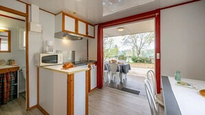A compact kitchen with a microwave, toaster, and a small island.