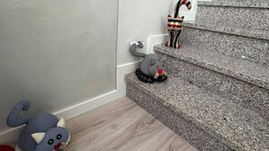 A staircase with a wooden handrail, a plush toy on the floor, and a striped toy on the steps. - La Casa della Nonna - Two Bedroom House, Sleeps 6 (Sale Marasino)