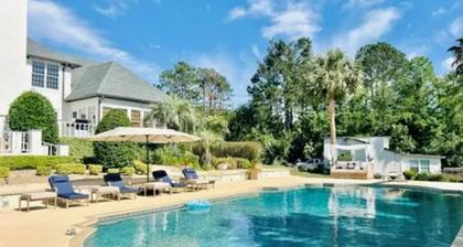 Resort style 5-bedroom lake house with white sand beach, pool, and pool house.