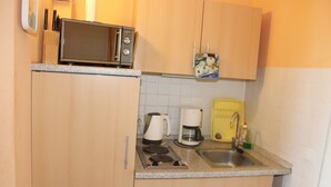 A kitchen with a microwave, coffee maker, and sink. - Holiday apartment on the Baltic Sea E312 (Schönberg OT Holm)