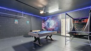 A pool table with a space-themed wall mural, a basketball hoop, and LED strip lighting. - Enchanted Palms Villa 7BR w Private Pool (Davenport)