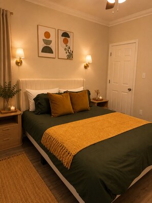 A neatly arranged bedroom with a bed, bedside lamps, a door, and wall art. - 2bed 2bath apartment in Baton Rouge 6 min. from LSU fast WiFi, and free parking (Baton Rouge)