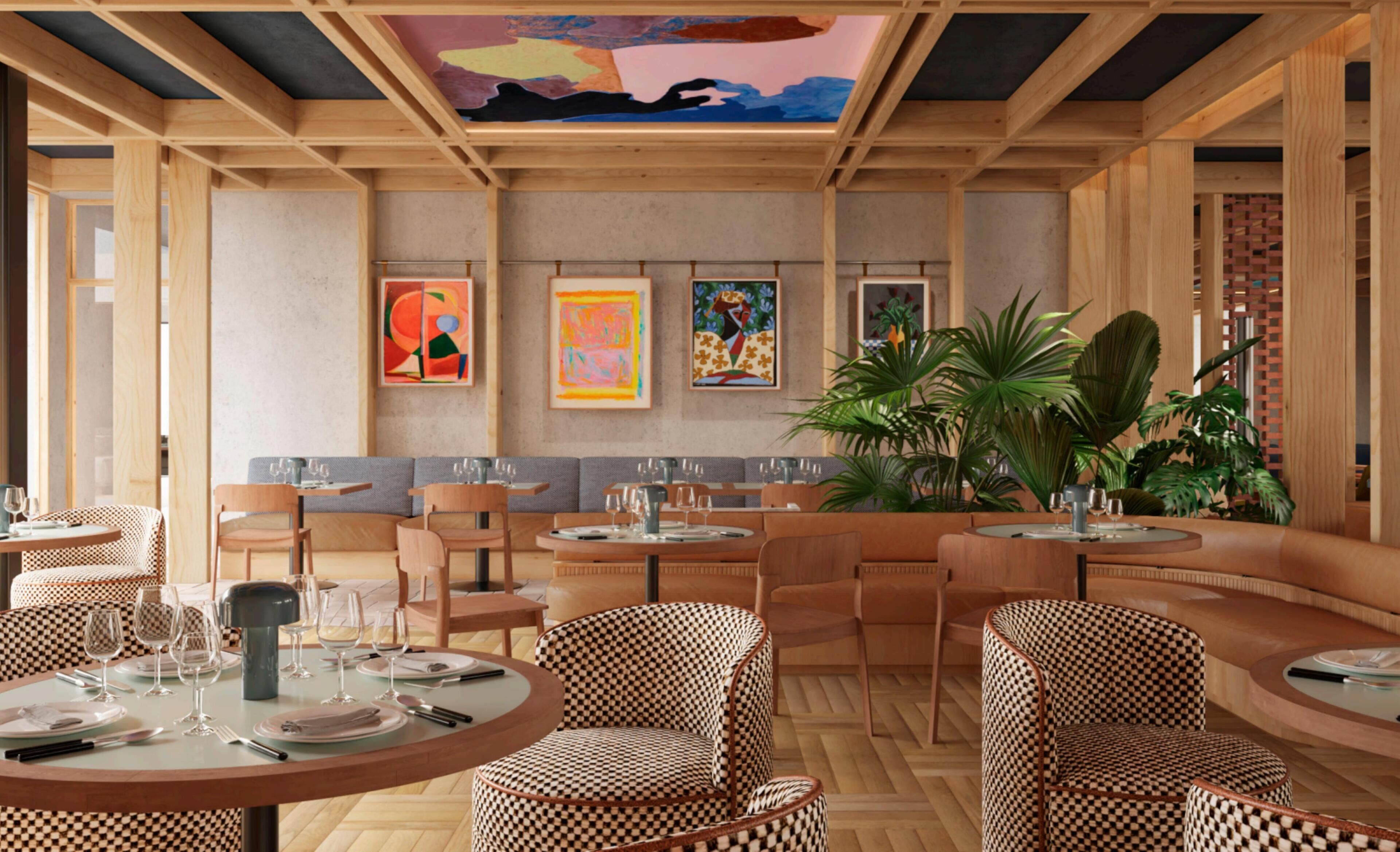 A restaurant interior with round tables, checkered chairs, and artwork on the walls.
