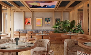 A restaurant interior with round tables, checkered chairs, and artwork on the walls. - Cuber House Valencia, Curio Collection By Hilton (Valencia)