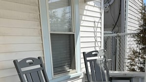 A wooden deck with two chairs and a small table. - Low Tide - Heart of Hampton Beach! (Hampton)