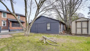 A residential area with a house, a shed, and a tree. - 4 Mi to Waterfront: 2-unit Combo in Kingston! (Kingston)