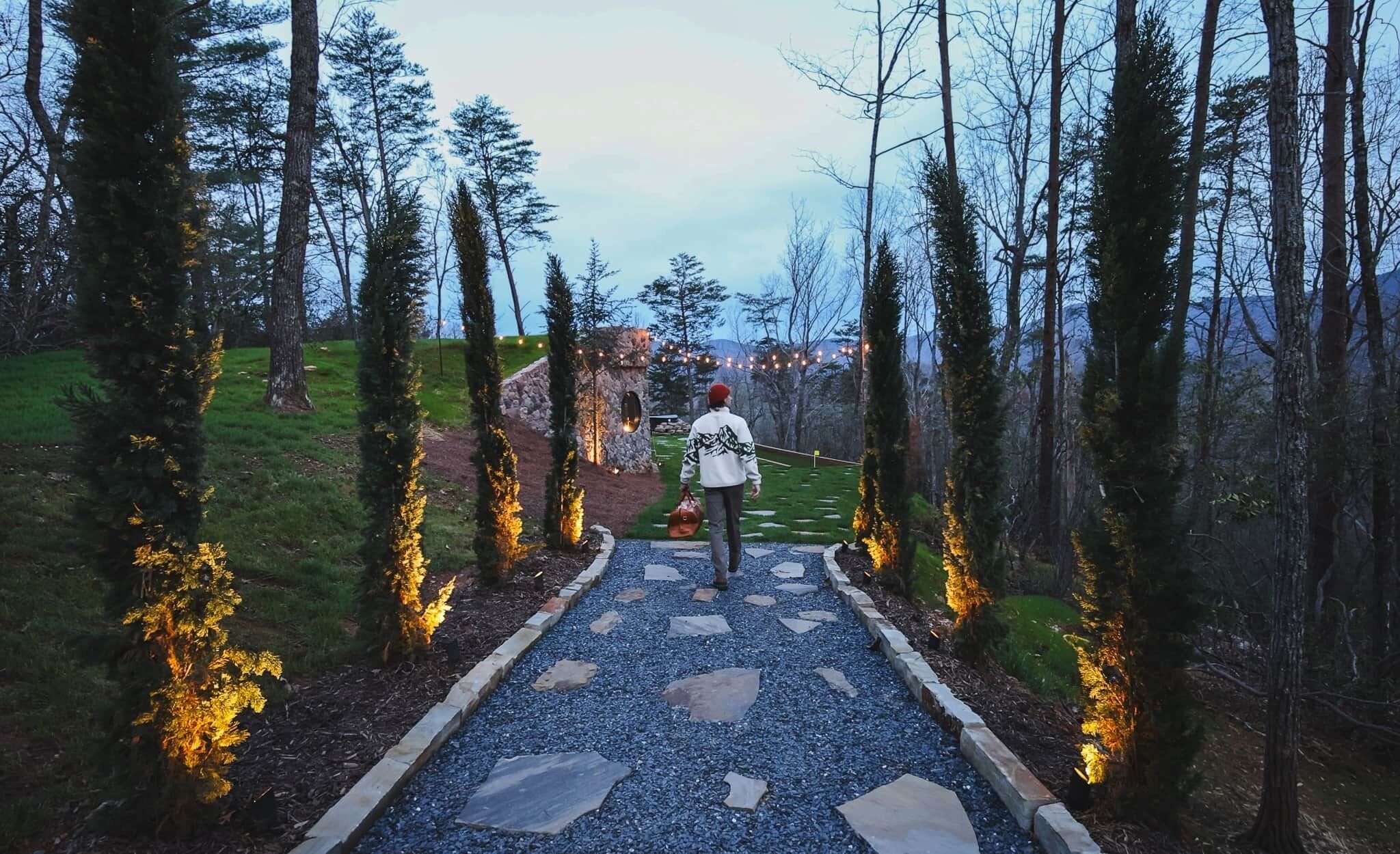 A pathway leading through a forest with stone steps and trees.