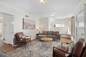 A living room with a sofa, armchairs, a coffee table, and a rug. - Adorable Westwood house newly updated, great central location! World Cup ready! (Kansas City)
