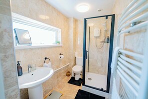 Shower, hair dryer, towels, shampoo