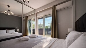A hotel room with a large bed, a smaller bed, a chandelier, a sliding glass door, and an air conditioning unit.