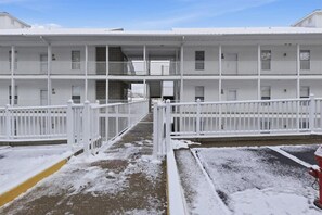 A multi-story white building with balconies and a central staircase. - Waterfront Lake of the Ozarks Retreat (Lake Ozark)