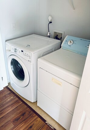 A laundry room with a front-loading washing machine and a stacked dryer. - Quiet Family 4BR l 3 Full Baths l Near ATL Airport l Sleeps 9 (Union City)