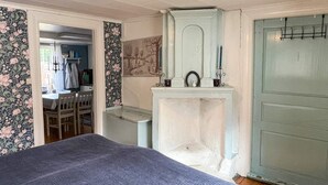 A room with a bed, a dresser, a mirror, and a door. - 2 Person Holiday Home in Morlunda (Mörlunda)