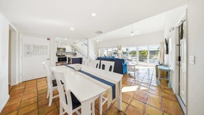 A spacious kitchen with a dining area, a staircase, and a view of the outside. - Sea Dreams on 9, 3 bedroom 3 bath 1/2 duplex, Private Pool in Key Colony Beach waterfront with 37 ft dockage and cabana club private membership, pool table and putting green. (Key Colony Beach)