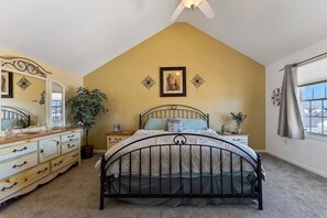 A bedroom with a bed, dresser, and a large window. - Gorgeous 4 Bedroom Townhome in Diamond Beach (Wildwood Crest)