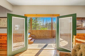 A wooden deck with a view of trees, a bench, and a small table. - Cabin Retreat Near Parkway, Hot Tub, Pool Table (Pigeon Forge)