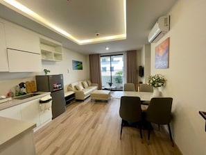 A modern apartment with a kitchen, dining area, and living room.