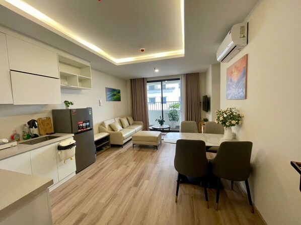A modern apartment with a kitchen, dining area, and living room.